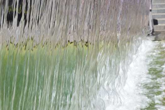 artificial waterfall, city fountain, close-up pouring water.