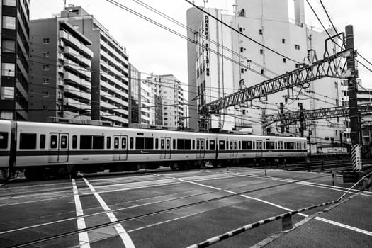 TOKYO, JAPAN - MAY 18, 2019 - Suburban train and train tracks near Shinjuku in central Tokyo, Japan