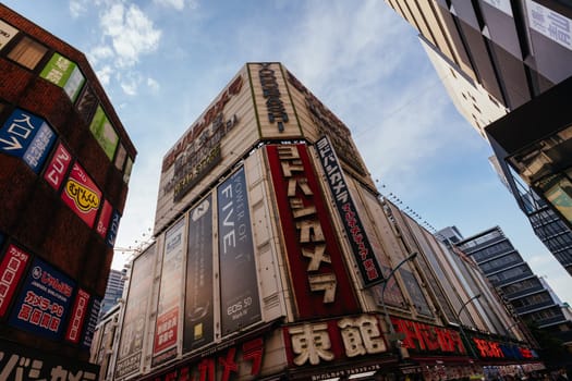 TOKYO, JAPAN - MAY 18 2019: Tokyo’s busy Shinjuku neighborhood during the day around Yodobashi camera store