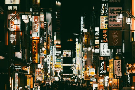 TOKYO, JAPAN - MAY 12, 2019: Neon signs illuminate Tokyo’s busy Shinjuku neighborhood at night