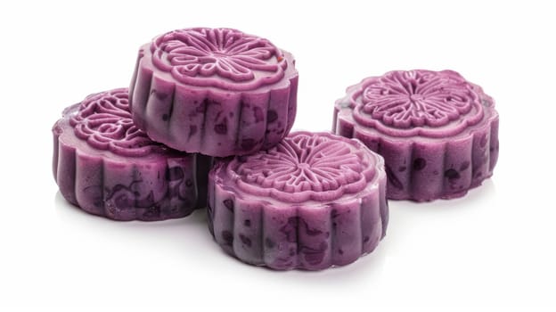 Delicious purple mooncakes beautifully arranged isolated on white