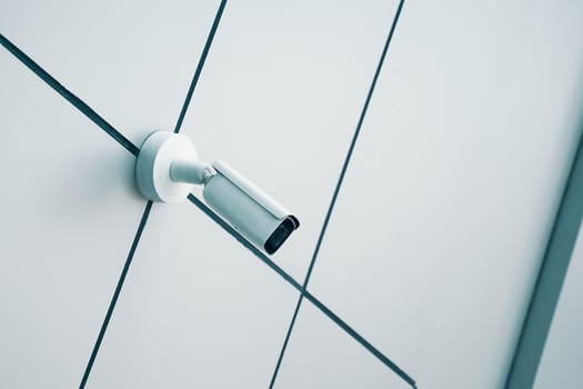 A sleek and modern security camera is securely mounted on a minimalist wall, ensuring safety and effective surveillance