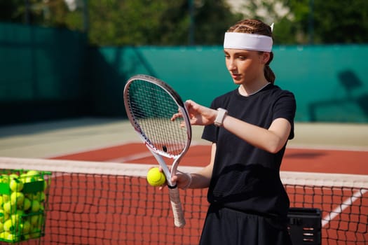 girl tennis player adjusts the strings of a tennis racket close-up during a match, against the background of a court, tennis game