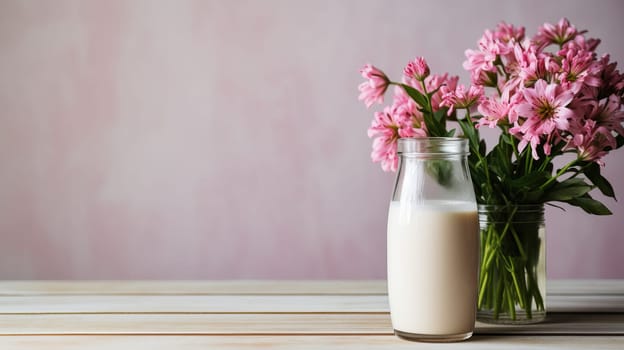 Bottle of milk and pink flowers on a wooden table, Dairy products, flowers and healthy breakfast concept