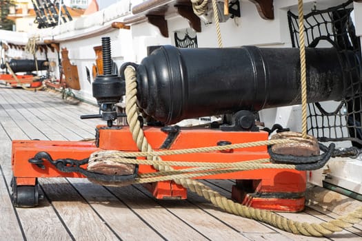 Historirical old cannon on battle sailing vessel - stand on deck