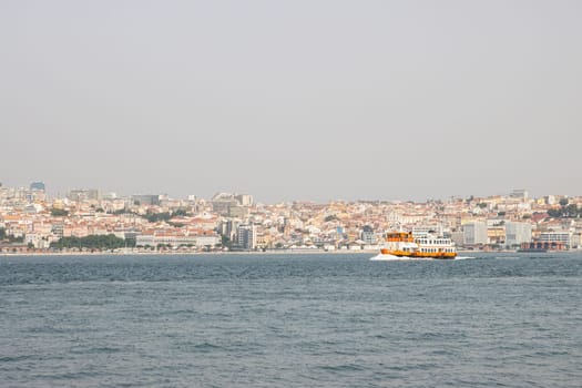 Lisbon, Portugal - 0510 2022 - Touristic ferry boat arriving to the station Almada, Lisboa Harbor
