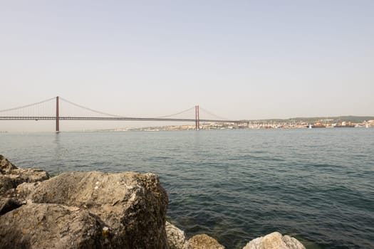 Bridge of 25 april - view of Lisboa Harbor with vessels and boats, day
