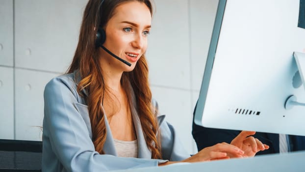 Business people wearing headset working in office to support remote customer or colleague. Call center, telemarketing, customer support agent provide service on telephone video conference call. Jivy