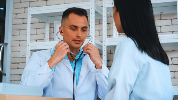 Doctor in professional uniform examining patient at hospital or medical clinic. Health care , medical and doctor staff service concept. Jivy