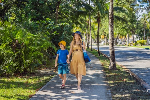 Expectant mother and her son enjoying a leisurely stroll in the park, cherishing precious moments amidst nature's beauty.