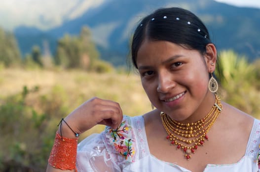 copy-space of beautiful indigenous woman looking at camera smiling while holding her blouse of typical ecuadorian dress. Hispanic Heritage Month. High quality photo