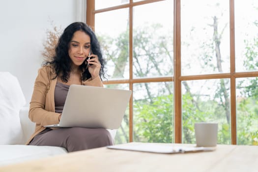 African-American woman using laptop computer for crucial work on internet. Secretary or online content writing working at home.