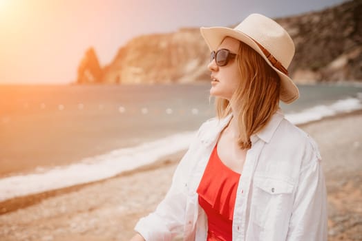 Young woman in red bikini on Beach. Blonde in sunglasses on pebble beach enjoying sun. Happy lady in one piece red swimsuit relaxing and sunbathing by turquoise sea ocean on hot summer day. Close up,