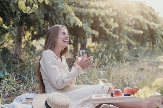 Picnic and wine tasting at sunset in the hills of Italy, Tuscany. Vineyards and open nature in the summer. Romantic dinner, fruit and wine.