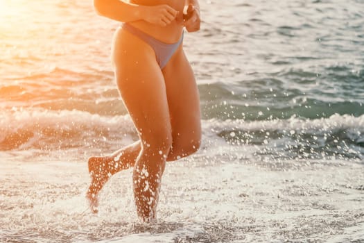 Running woman. Female runner jogging during the sunrise on beach. Woman Runner feet running on the beach at sunrise. woman fitness sunrise jog workout wellness concept.