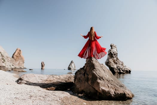 Woman travel sea. Happy tourist taking picture outdoors for memories. Woman traveler looks at the edge of the cliff on the sea bay of mountains, sharing travel adventure journey.