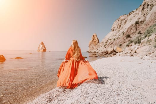 Woman travel sea. Happy tourist taking picture outdoors for memories. Woman traveler looks at the edge of the cliff on the sea bay of mountains, sharing travel adventure journey.