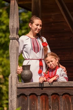 mother with daughter and jug in historical clothes