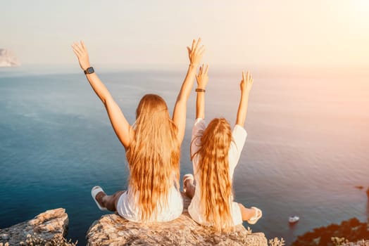 Close up portrait of mom and her teenage daughter hugging and smiling together over sunset sea view. Beautiful woman relaxing with her child.