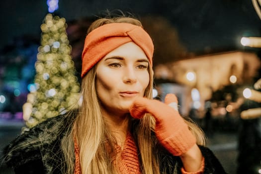 Winter fun on the street: Girl with sparklers, smiles in warm jacket and hat. Festive Christmas or New Year celebration,