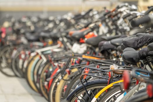 Netherlands. Modern Dutch background. Row of bicycles in a bicycle parking lot near Amsterdam Central Station