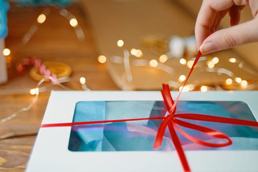Christmas composition with present box. Festive gift box inside with red ribbon.