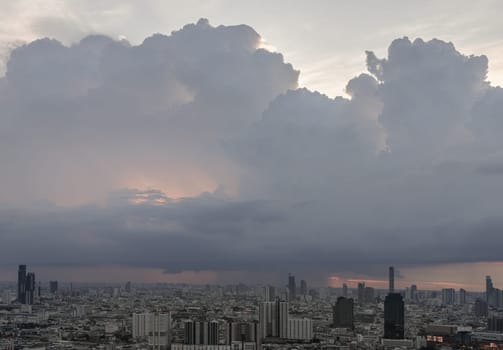 Bangkok, Thailand - 28 May 2024 - Beautiful clouds in the sky over large metropolitan city of bangkok. Aerial view of skyscrapers and dramatic sky before sunset, Copy space, Selective focus.