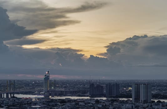 Bangkok, Thailand - 22 Aug 2024 - Beautiful skyscrapers view and the Bridge crosses the Chao Phraya river of Bangkok city with Dramatic sky background at before sunset. use it as your wallpaper, poster and banner design, Selective focus.