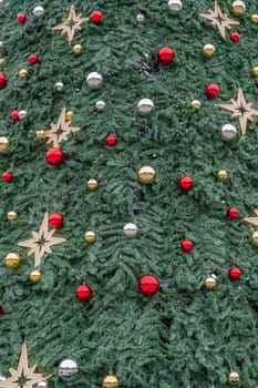 A beautifully adorned Christmas tree is covered in red, silver, and gold ornaments, alongside shining stars, creating a festive atmosphere perfect for the holiday season.