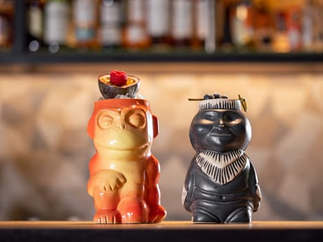 Tiki Drink Cocktails. Two tropical tiki cocktails on bar counter. Tiki cocktails on bar in night club