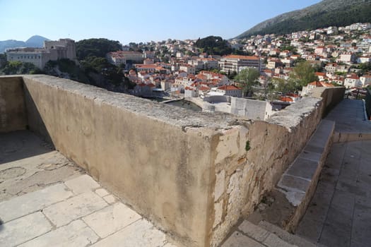 Dubrovnik, Croatia, old town, tiled roof of a house ancient stone building with a triangular facade top view travel places, windows blue sky landscape architecture April 22, 2023. High quality photo