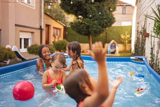 Kids enjoy a fun afternoon together in a sunny backyard pool.