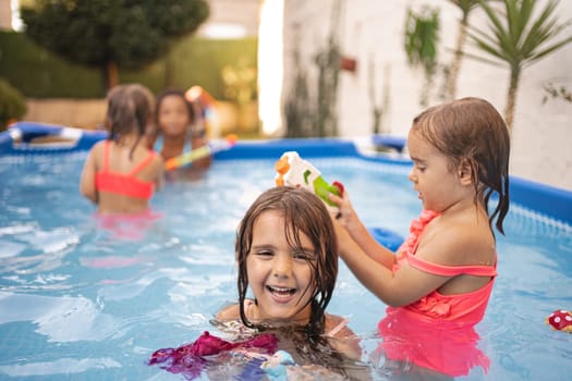 Kids are having fun splashing water and enjoying summer activities.