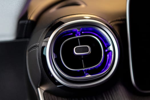 Close-up of a luxury car's interior dashboard, showcasing advanced technology and design with stylish air vents.