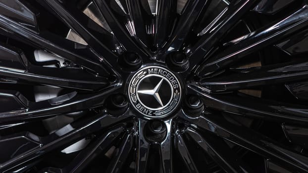 Kyiv, Ukraine - September 12, 2024 : Sleek black Mercedes-Benz car wheel showcasing the elegant rim design and iconic Mercedes-Benz logo