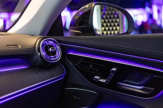 Luxury car interior featuring ambient lighting, sleek design, and premium materials