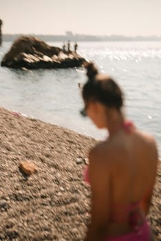 A tranquil beach scene with a person enjoying the warm sun and inviting water, capturing the essence of summer