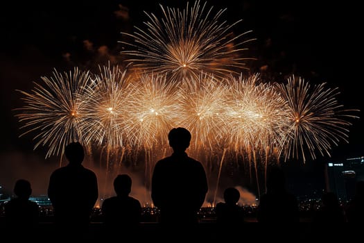 Explosive bursts of color fill the night sky, captivating a group of onlookers silhouetted against the dazzling display, embodying the spirit of celebration and wonder.