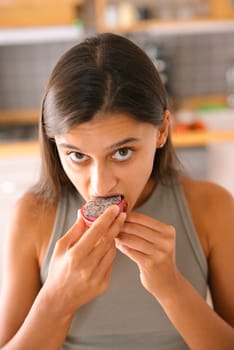 A woman enjoys a juicy passion fruit, highlighting a vibrant, healthy snack lifestyle ideal for mindful eating