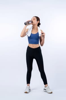 Athletic and sporty asian woman resting and drink water after intensive cardio workout training. Healthy exercising and fit body care lifestyle pursuit in studio shot isolated background. Vigorous