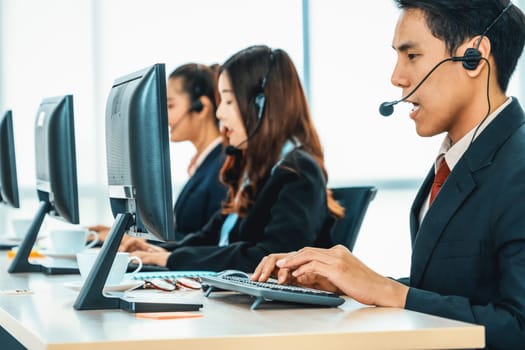 Business people wearing headset working in office to support remote customer or colleague. Call center, telemarketing, customer support agent provide service on telephone video conference call. Jivy