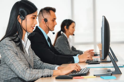 Business people wearing headset working in office to support remote customer or colleague. Call center, telemarketing, customer support agent provide service on telephone video conference call. Jivy