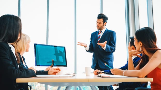 Business people in the conference room with green screen chroma key TV or computer on the office table. Diverse group of businessman and businesswoman in meeting on video conference call . Jivy