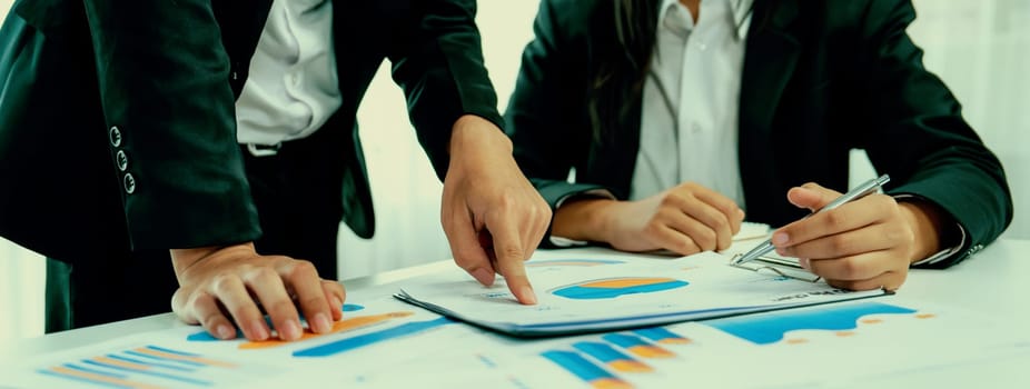 Business people in group meeting in formal attire share idea discussing report for company profit in creative workspace for start up business shot in close up view on group meeting table . Oratory .