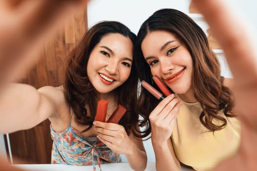 Asian Woman influencer shoot live streaming vlog video review makeup uttermost social media or blog. Happy young girl with cosmetics studio lighting for marketing recording session broadcasting online