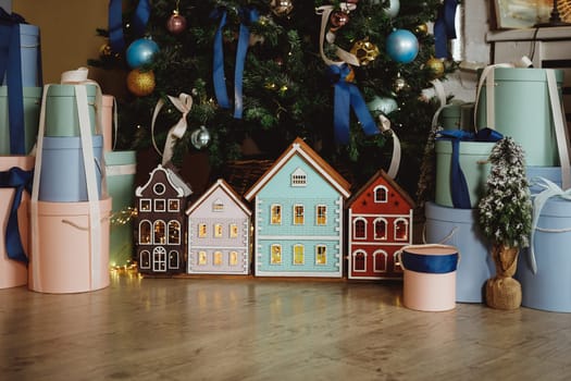 Gift boxes under the Christmas tree close-up. Gifts near the Christmas tree in blue and white paper.