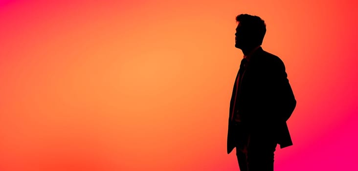 A person stands in profile against a backdrop of warm, glowing sunset colors. The scene captures tranquility and introspection in a beautiful outdoor setting.