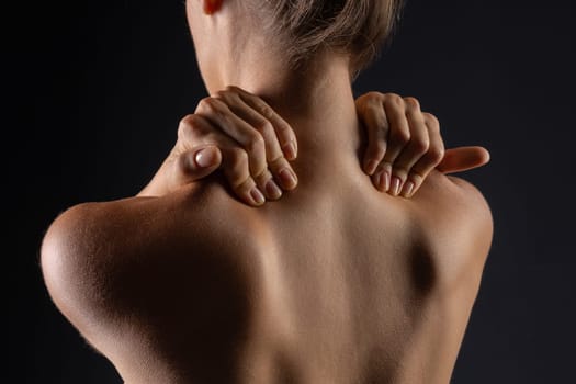 woman massaging neck close-up, concept of neck pain with osteochondrosis protrusion and hernia in the cervical spine,