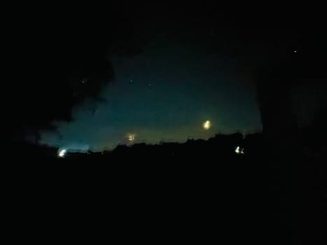 a night sky with trees and stars. High quality photo