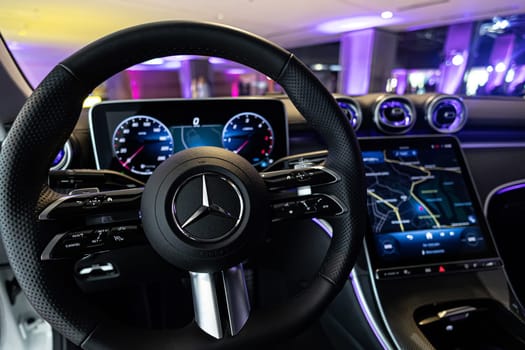 Kyiv, Ukraine - September 12: Mercedes-Benz luxury car interior showcasing the sleek design of the steering wheel, digital dashboard, and advanced navigation system